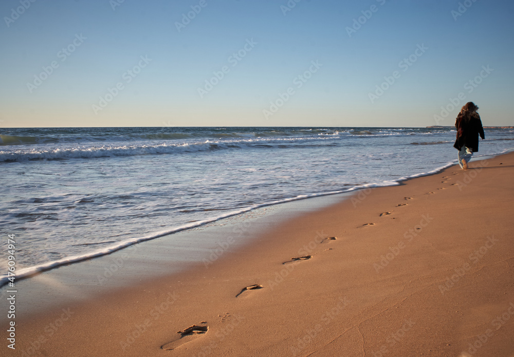 Girl walking on the beach. 