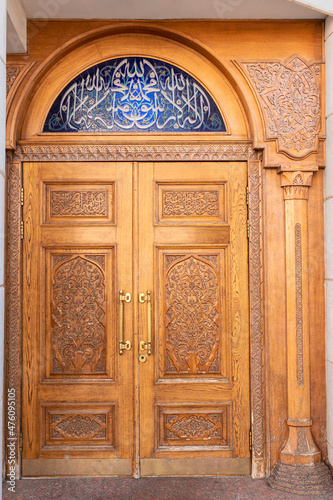 Kazan, Russia - May 16, 2021 - Beautiful wooden door with ornate oriental carvings on wooden door panels in the historical part of the city