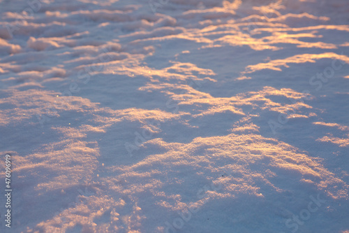 Fresh snow texture background in blue tone and sunlight.