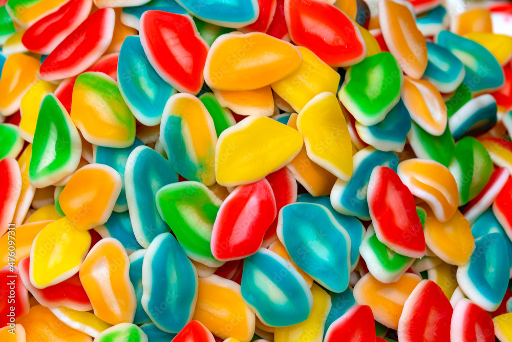Texture of yellow, red and green and blue jelly candies. Sweets on a pile close up