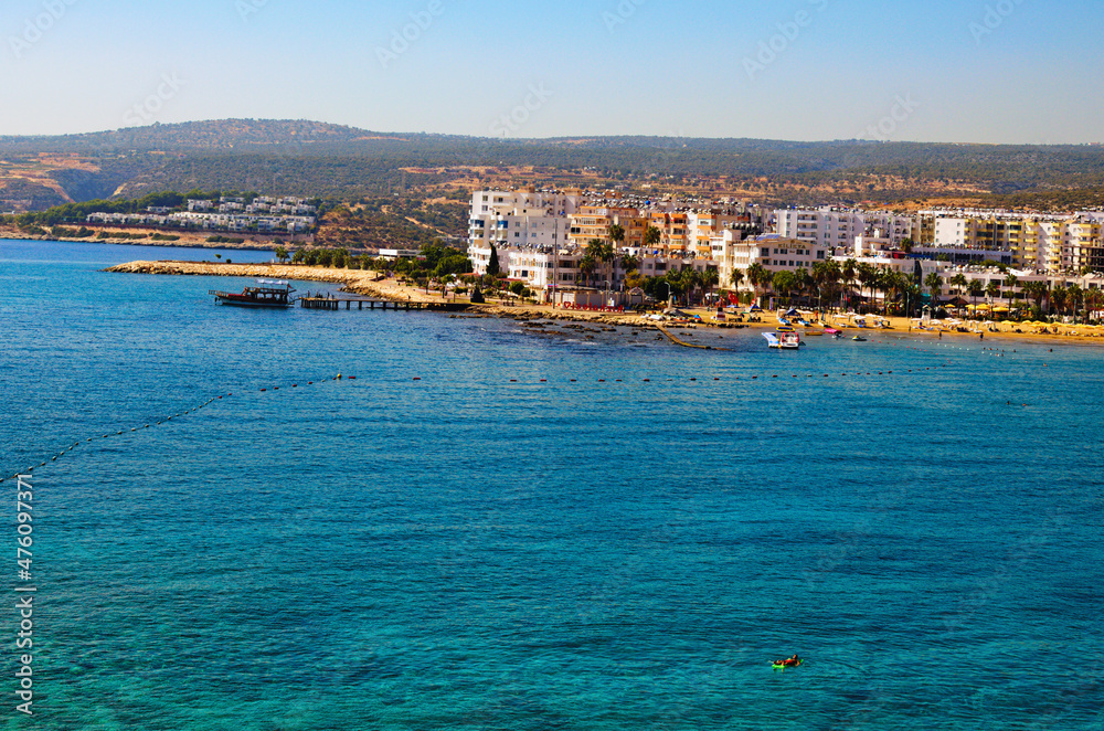 Kizkalesi, Turkey-October 11,2021:Wide angle landscape view of blue water of Mediterranean Sea and city beach, embankment with many hotels in Kizkalesi. Blue sky background. Famous touristic place