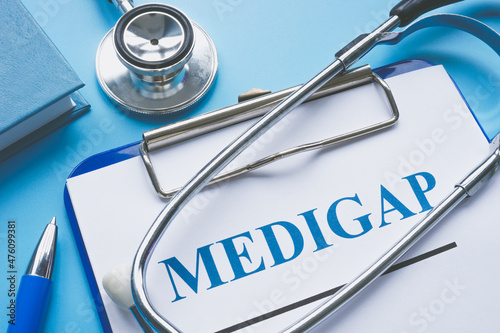 Medicare Supplement Insurance Medigap application and stethoscope. photo