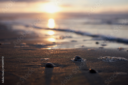 Reflection of cloudy sky on wet sand, beach