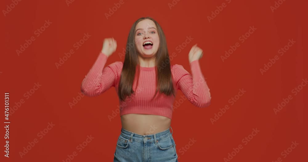 Overjoyed young girl champion rejoice success, feel euphoric with achievement, celebrate win, shout yes, raising hands Overjoyed young girl champion rejoice success, feel euphoric with achievement, celebrate win, shout yes, raising hands