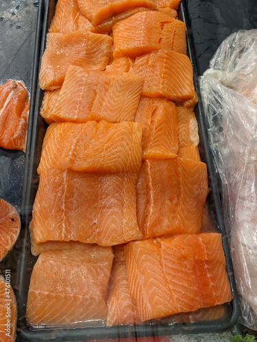 Sliced salmon portions for sale in a fish market