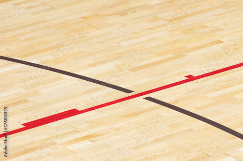 Wooden floor basketball, badminton, futsal, handball, volleyball, football, soccer court. Wooden floor of sports hall with marking red and brown lines on wooden floor indoor, gym court