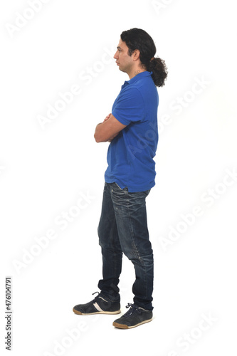 side view of a man with ponytail and arms crossed on white background