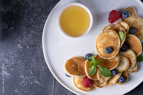 tasty pancakes and berries on white plate