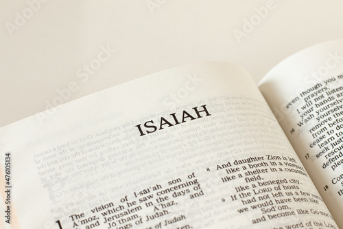 Open Holy Bible Isaiah prophet Book Old Testament Scripture on white background. Christian biblical concept of prophecy, trust, and faith in God Jesus Christ. Reading the Word of the LORD. A close-up. photo