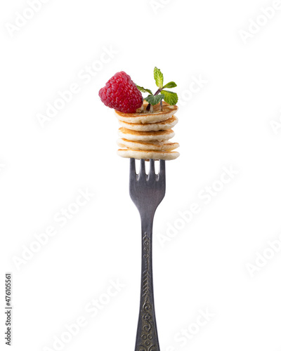 Freshly Baked American Mini Pancakes on a Fork With Fresh Berry Tasty Breakfast white Background.