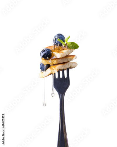 Freshly Baked American Mini Pancakes on a Fork With Fresh Berry Tasty Breakfast white Background.