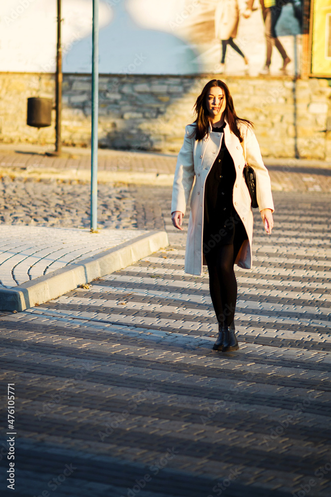 Obraz premium A girl walking through a pedestrian crossing