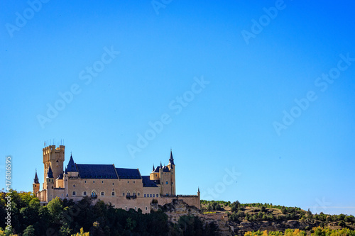 Dream castle seen from afar with trees and a blue sky