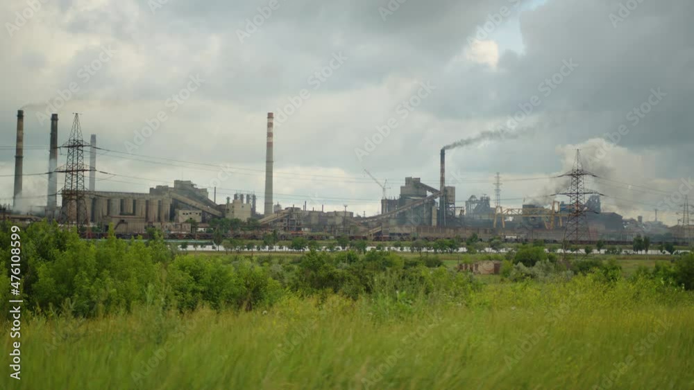 Toxic enterprise chimneys tubing against the sky background release smoke. Factory pollutes environment. Ecology pollution concept Toxic enterprise chimneys tubing against the sky background release smoke. Factory pollutes environment. Ecology pollution concept