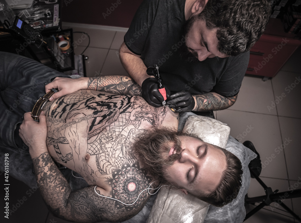 © Mr. Prof - Tattooer makes tattoo pictures in tatoo salon © Mr. Prof - Tattooer makes tattoo pictures in tatoo salon