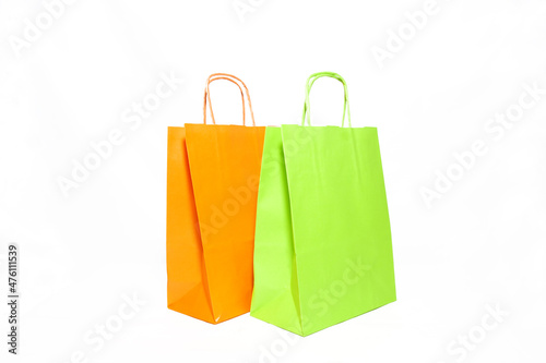 Green and Orange shopping bags. Side by side, isolated on white background. 