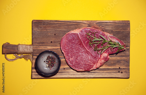 raw beef steak on woodern background photo