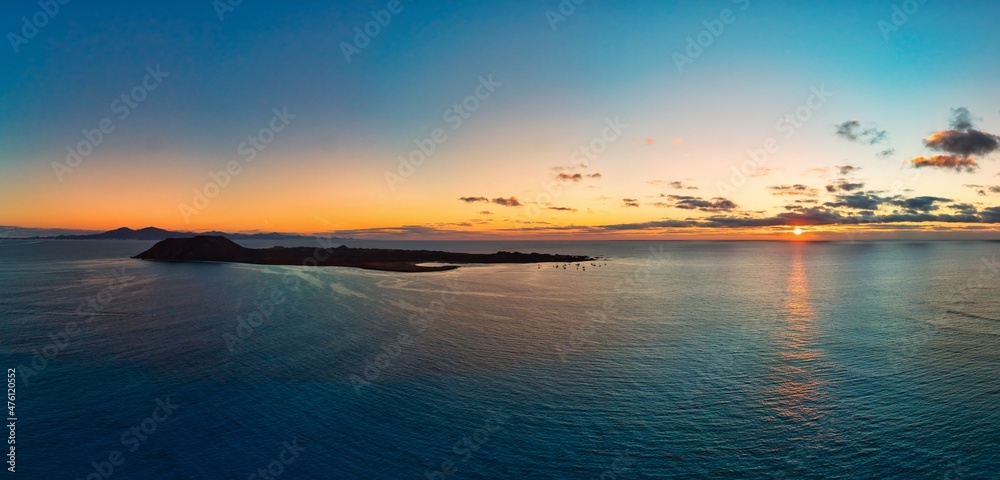 Beautiful panoramic view of the sunrise over Isla de Lobos island Corralejo Fuerteventura