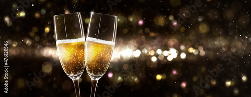 Canvas Print celebrating new year 2022 with 2 glasses of champagne on beautiful unfocused bac