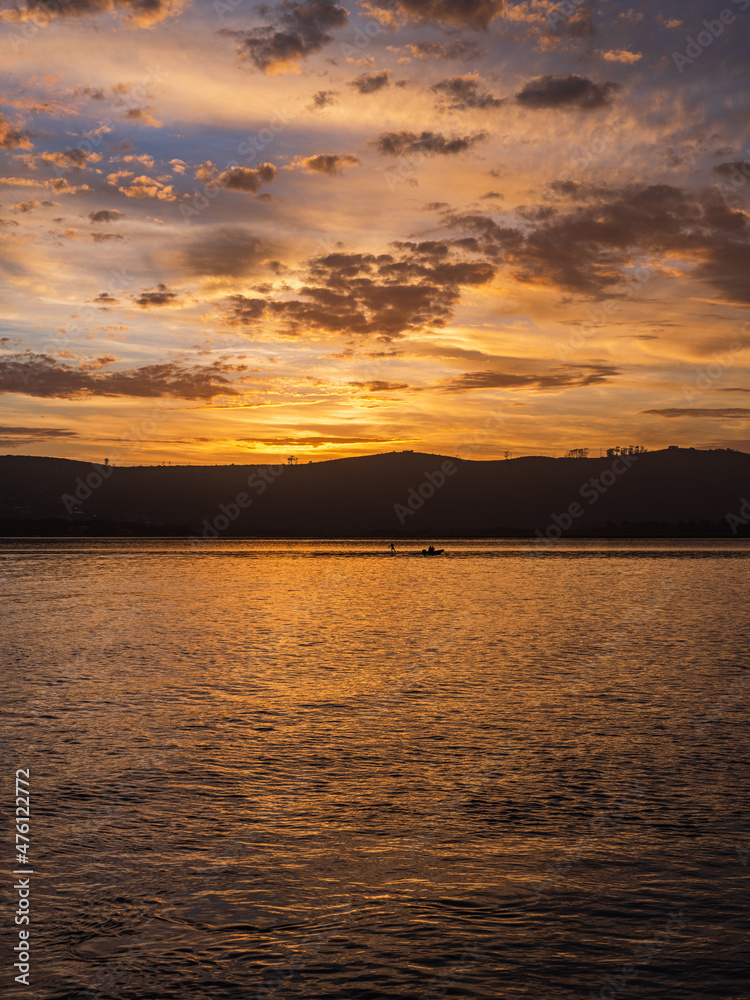 Golden sunset with dramatic sky clouds over Knysna lagoon