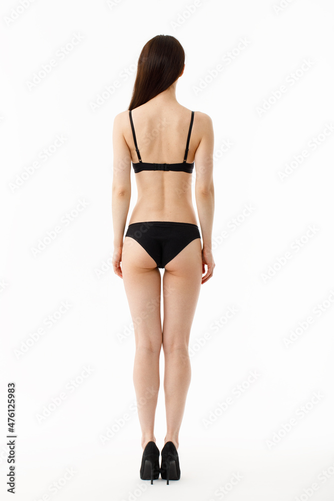Model tests. Snap Models back view, Beautiful brunette woman in underwear, isolated on white.