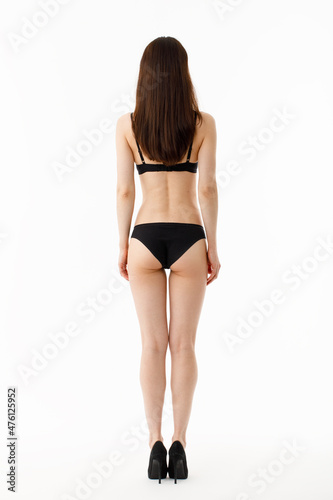 Model tests. Snap Models back view, Beautiful brunette woman in underwear, isolated on white.