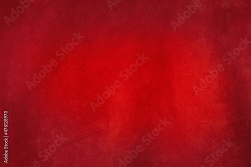 A macro photo of a red suede leather with slight folds. Red background.