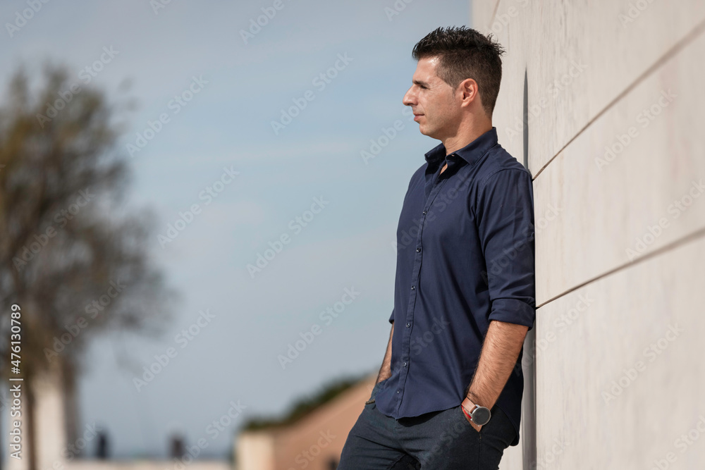 Portrait of a beautiful young man posing for a photo session along the tejo riverside in Lisbon, Portugal. Stylish freelance architect relaxing alone near the urban concept building in downtown. Portrait of a beautiful young man posing for a photo session along the tejo riverside in Lisbon, Portugal. Stylish freelance architect relaxing alone near the urban concept building in downtown.