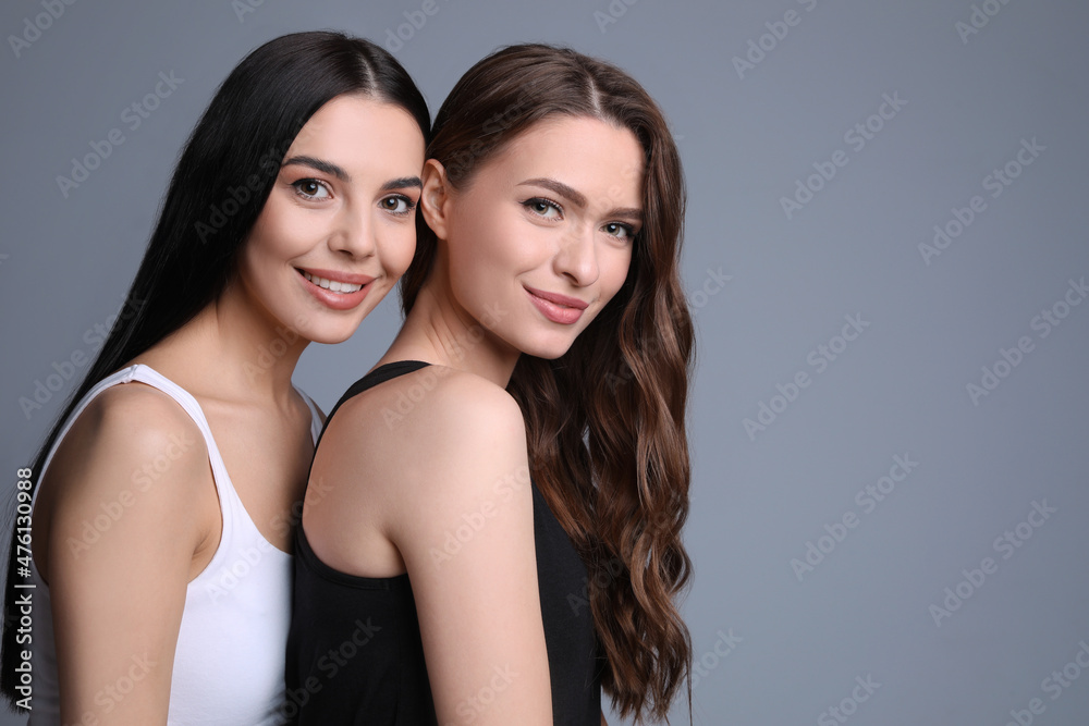 Portrait of beautiful women on grey background, space for text Portrait of beautiful women on grey background, space for text