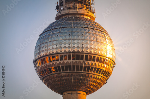 Closeup shot of the tv tower in berlin with asunset refection photo