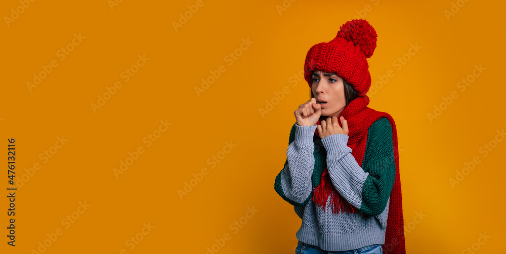 Sad woman portrait with some virus, flu, or cough in warm winter hat and scarf while she is ill
