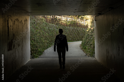 Woman Walks Through Concrete Tunnel