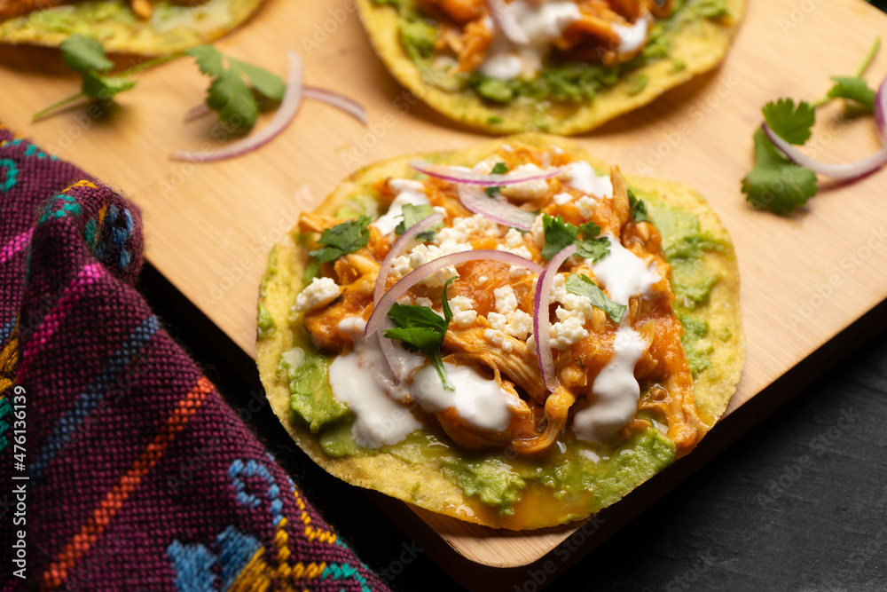 Chicken tinga tostadas with cheese and avocado. Mexican food Chicken tinga tostadas with cheese and avocado. Mexican food