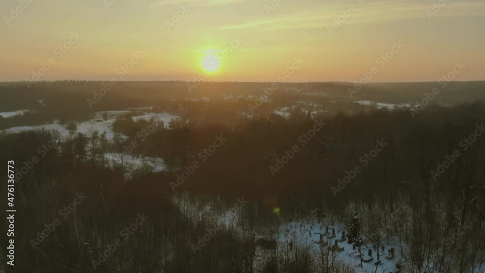 Landscape with a winter mountain forest during a snowfall with aerial view Landscape with a winter mountain forest during a snowfall with aerial view