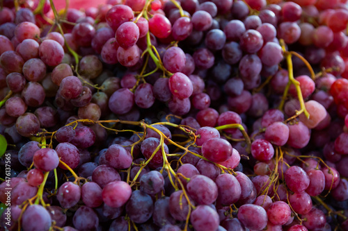 Fresh bunches red grapes on counter in food market