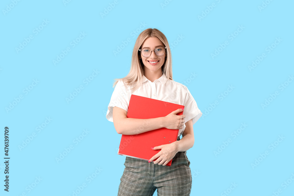 Pretty young woman with red folder on blue background Pretty young woman with red folder on blue background