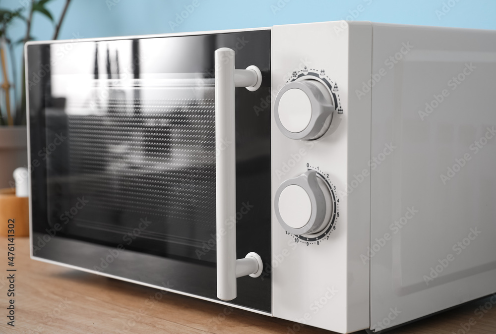 Fototapeta premium Modern microwave oven in kitchen, closeup