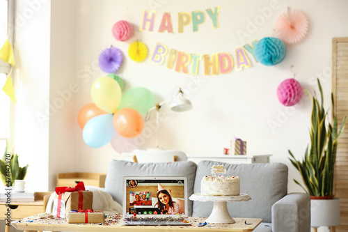 Laptop, gifts and cake on t...