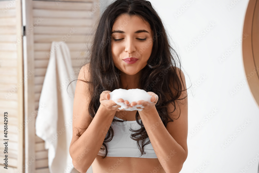 Morning of beautiful young woman playing with soap foam in bathroom Morning of beautiful young woman playing with soap foam in bathroom
