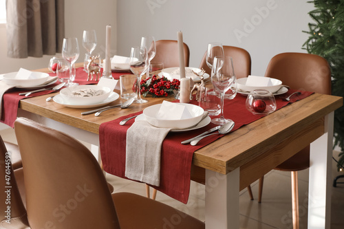 Festive table setting for Christmas celebration in dining room