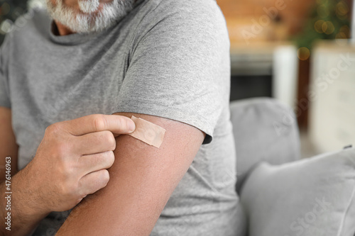 Картината върху платно Mature man with applied nicotine patch at home, closeup