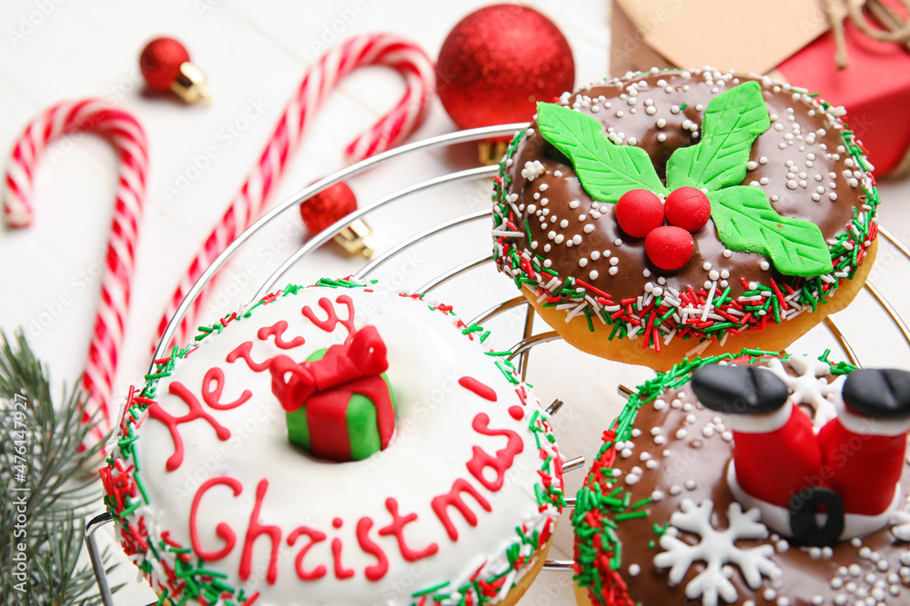 Grid with tasty Christmas donuts on white background, closeup Grid with tasty Christmas donuts on white background, closeup