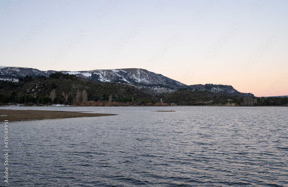 The lake, forest and mountains at sunset.