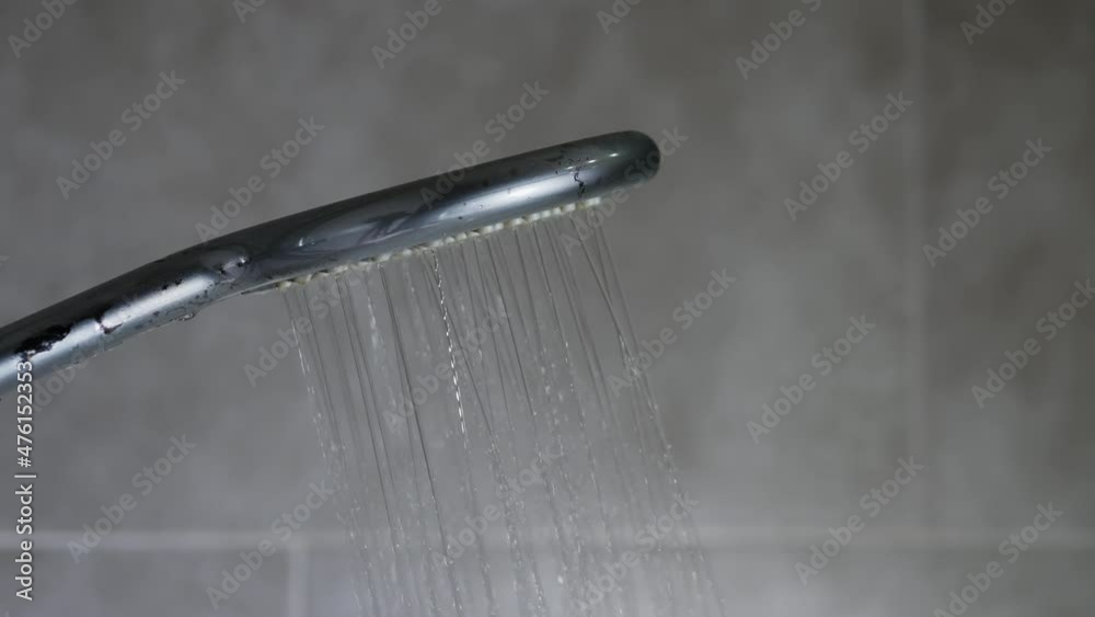 Turning on the shower, the flow of water from the shower head in the