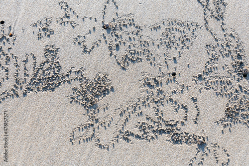 Patterns left on a tropical beach by sand or ghost crabs in Thailand photo