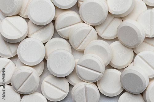 Lots of round, white pills. Pharmacy. Medicines. Background, wallpaper, texture.	