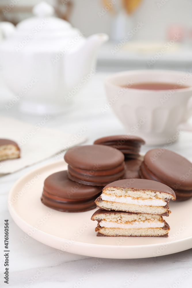 Plate with delicious choco pies on white marble table in kitchen Plate with delicious choco pies on white marble table in kitchen