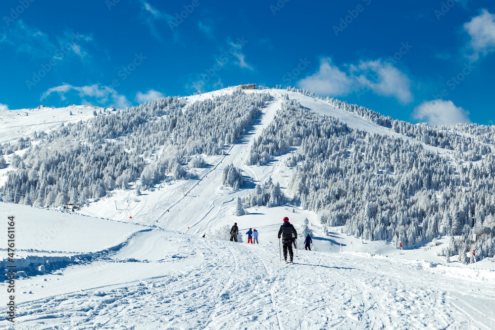  snowboarder is jumping with snowboard from snowhill. Skier skiing downhill in high mountains. Flying skier on mountains, winter extreme sport. 