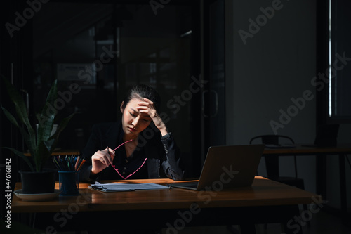 Young asian business woman suffering stress working at office.