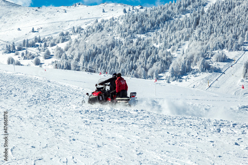  snowboarder is jumping with snowboard from snowhill. Skier skiing downhill in high mountains. Flying skier on mountains, winter extreme sport. 